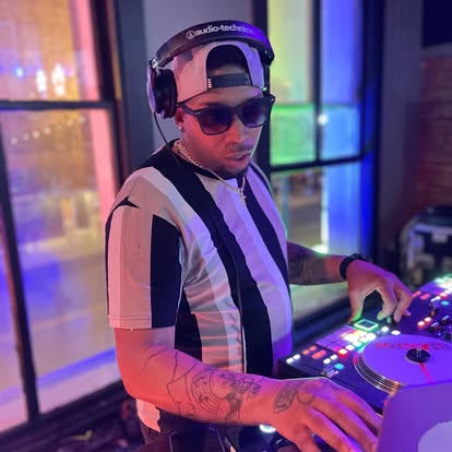DJ Endy performing under neon lights