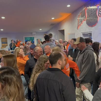 Packed private event crowd in orange
